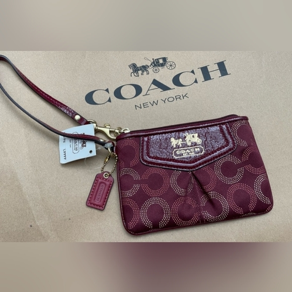 Coach Handbags - Coach Burgundy Wristlet. NWT. With Paper Coach Shopping Bag.